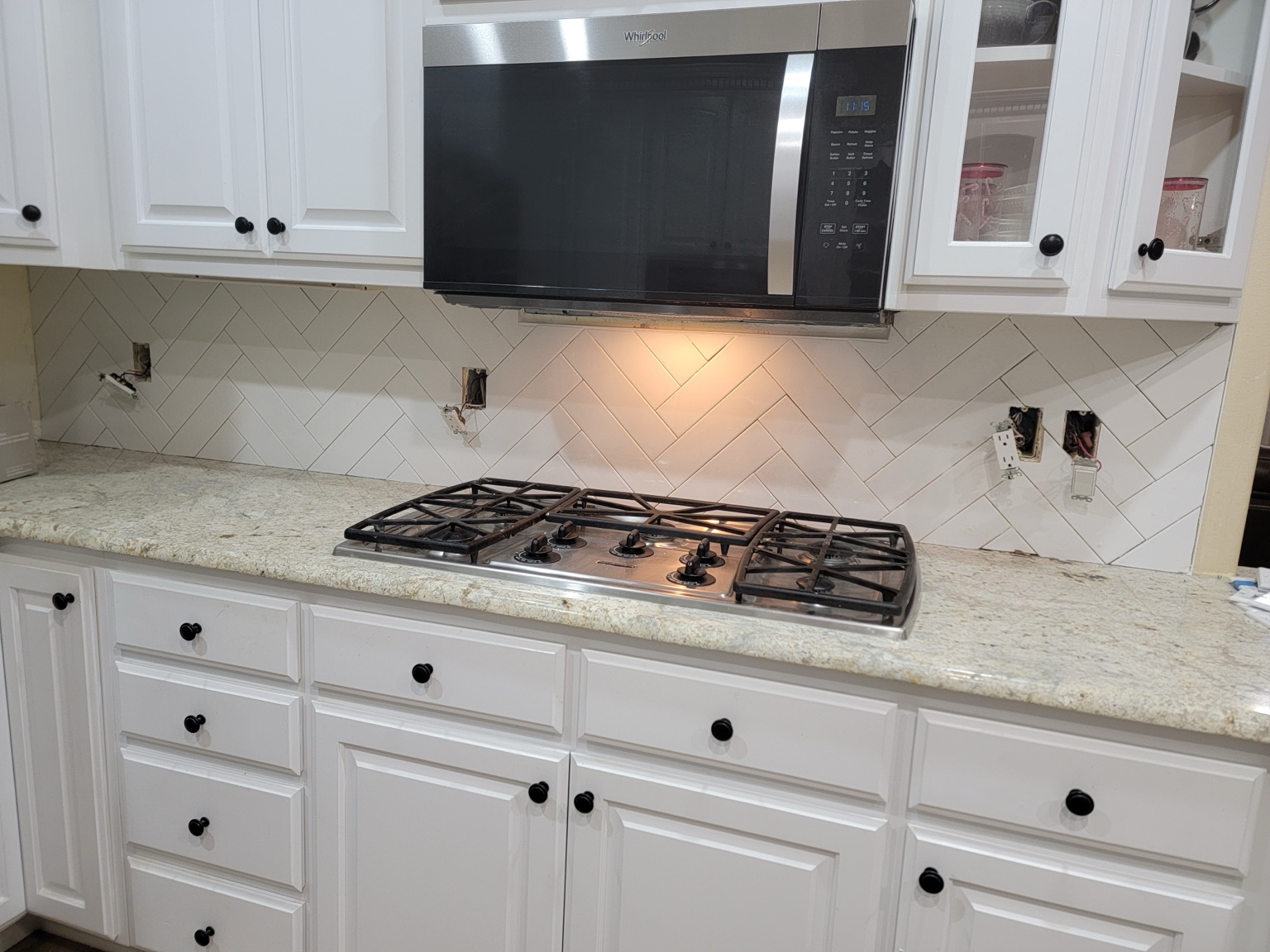 Herringbone kitchen backsplash during installation