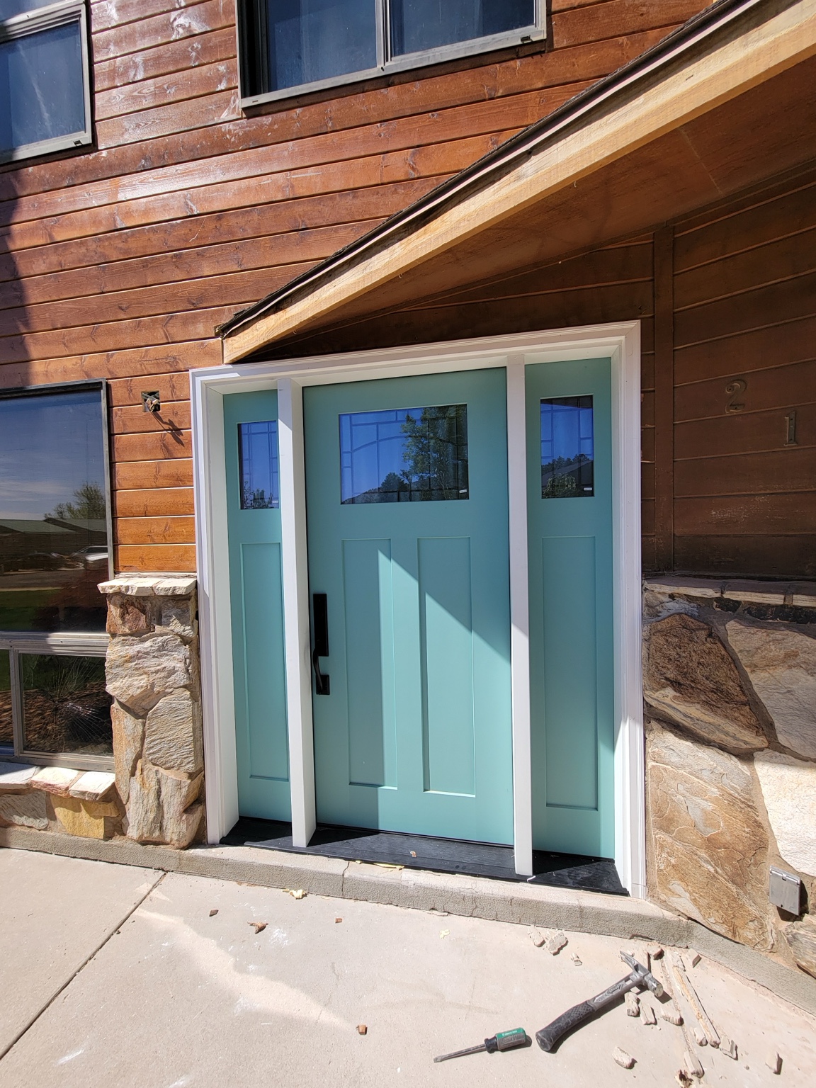Turquoise entry door and sidelights with white trim