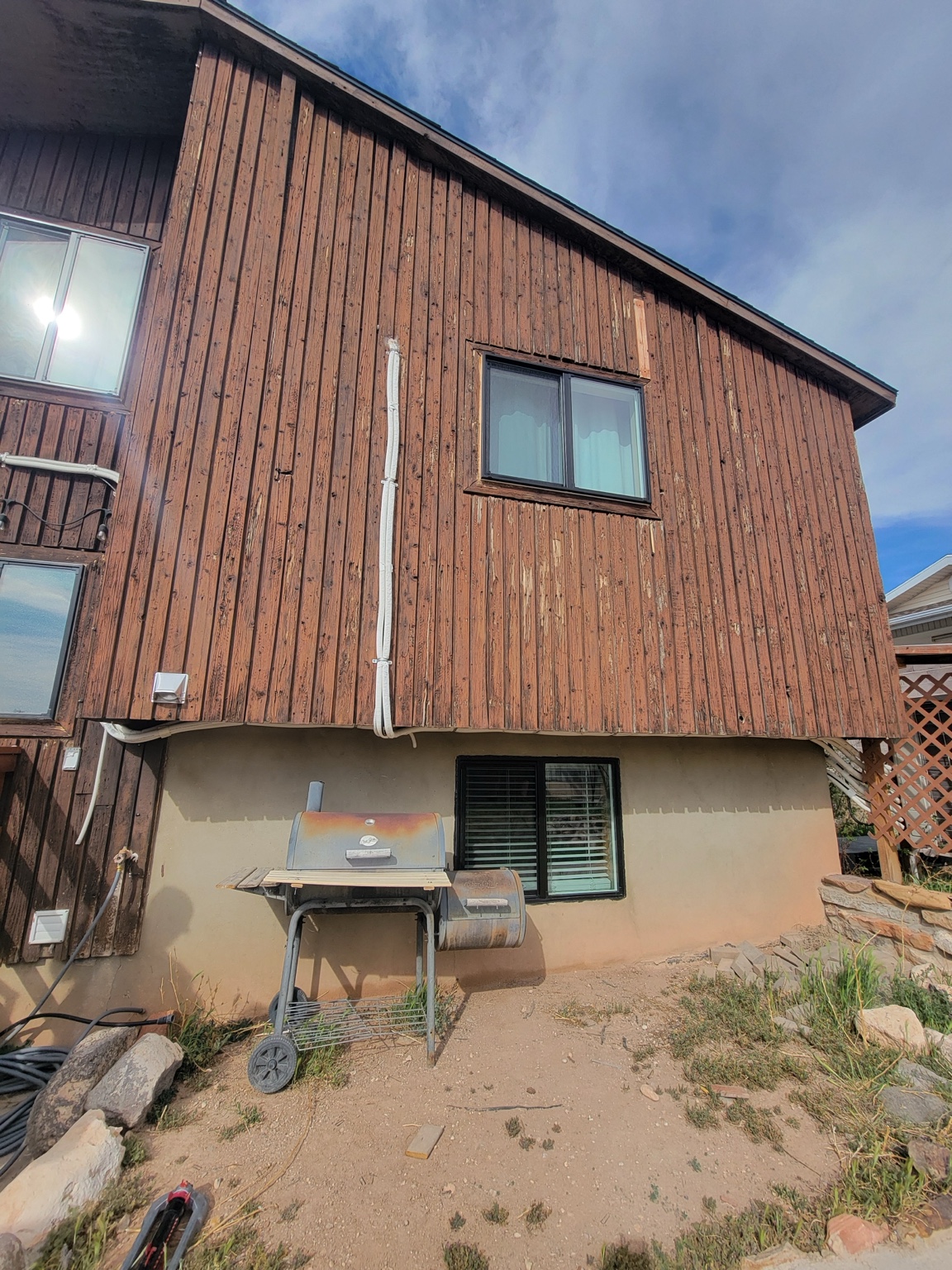 Weathered wood siding at the rear of the home