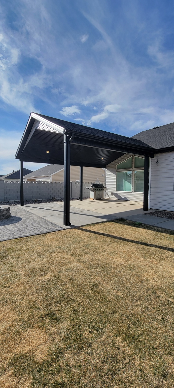 Finished patio cover with dark posts and soffit